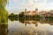 Telc with historical buildings, church and a tower. Buildings in water reflection