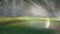 Tele-shot of a water irrigation in public park with abstract bokeh