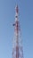 A telecom antenna tower during a cloudless day taken from below