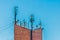 Telecommunication brick tower with mobile wireless antennas on blue sky background