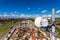 Telecommunication equipment with microwave antennas of mobile operator against blue sky with clouds and city