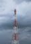 Telecommunication pole tower in cloudy sky