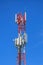 Telecommunication pylon with signal repeaters and antennas against blue sky for wireless technology and broadcasting industry
