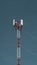 Telecommunication radio mobile tower antenna on the vast blue sky background. Transmitter internet global telephone equipment.