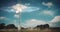 Telecommunication tower with 5G cellular network antenna in a field against a cloudy blue background. Base station receiver.