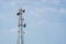 Telecommunication tower with blue sky background.