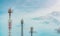 Telecommunication tower with blue sky and white clouds. Antenna on blue sky. Radio and satellite pole. Communication technology.