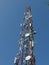 Telecommunication tower with blue skyline