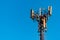 Telecommunication tower with clear blue sky background. Antenna on blue sky background. Radio and satellite pole. Communication