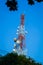 Telecommunication tower and cloudy blue sky with foreground of p