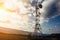 Telecommunication tower with dish and mobile antenna on mountains at sunset sky background