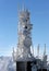 Telecommunication tower frozen under blue sky