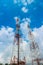 Telecommunication Tower. Mobile Phone Signal Tower on cloudy blue sky background