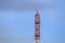 Telecommunication tower red and white antenna radio telephone mobile on sky background