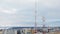 Telecommunication towers in background of cloudy sky and cityscape in winter day