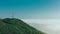 Telecommunication towers on top of a mountain against a background of clouds and fog. Mountain landscape