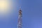 Telecommunication towers with wireless antennas on sky background with solar illumination. Cellular phone antenna