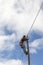 Telecommunication worker installs the fiberglass cable for speed internet at an electric pylon