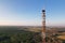 Telecommunications tower on the background of the blue sky in the countryside.