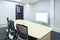 teleconferencing, video conference and telepresence business meeting room with white blank display screen