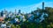 Telegraph Hill with Coit Tower on blue sky day aerial with distant San Francisco skyscrapers