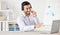 Telemarketing, man with a headset and laptop at his desk of a modern office workstation. Consultant or online