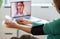 telemedicine concept elderly woman speaking to her doctor online and taking her blood pressure