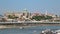 TELEPHOTO shot of a boat passing beneath The Elisabeth Bridge with The Buda Castle and The Fisherman`s Bastion in the background