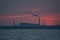 Telephoto view of epic red sunset over Dublin port and Covanta Plant Dublin Waste to Energy seen from west pier, Dun Laoghaire