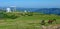 Telescope in Caucasus mountains. In the foreground horses grazing grass