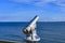 Telescope with coin slot on the pier in Bansin on the island of Usedom in Germany. Sea and sky are dark blue and radiate