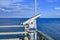 Telescope with coin slot on the pier in Bansin on the island of Usedom in Germany. Sea and sky are dark blue and radiate