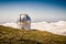 Telescope observatory on a mountain above the clouds. Gran Telescopio Canarias. Telescope dome overlooking the mountain landscape