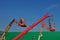 Telescopic crane and two aerial platforms of cherry pickers in a construction site