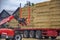 Telescopic handler Manitou Maniscopic take bales from a truck. Day view. Work in port