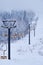 Teletsky Altai winter mountain ski resort near Iogach. Elevator on mount and forest background under snowfall