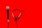 Television concept. Microphone and headset on red background top-down copy space