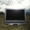 Television in grassy field.