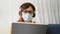 telework. woman in a medical mask works remotely in a digital tablet wearing a medical protective mask. office home