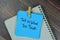 Tell Us What You Think write on sticky notes isolated on Wooden Table