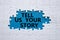 Tell us your story symbol. Concept words Tell us your story on white puzzle. Beautiful blue background. Business and Tell us your