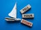 Tell your story symbol. Wooden blocks with words Tell your story. Beautiful blue background with boat. Business and Tell your