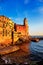 Tellaro rocks, church and village on sunset. Cinque terre, Ligur