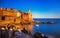 Tellaro rocks, church and village on sunset. Cinque terre, Ligury Italy