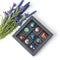Tempered chocolate candies with glossy painted body in a box with blur elements. View from above