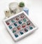 Tempered chocolate candies with glossy painted body in a box with blurred background and bokeh elements