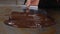 Tempering of the chocolate on the metal surface. Production of chocolates.