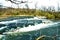 Tempestuous river with small stone rapids