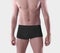 Template black cotton masculine boxers on a man, close-up, brief trunks isolated on the background in the studio