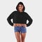 Template female crop top on a beautiful girl in a hood with hands on a belt, an empty black hoodie for design presentation